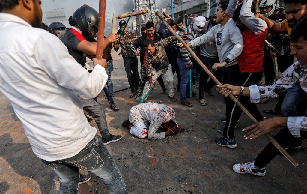 New delhi streets turn into battleground, hindus vs. muslims; police officers encouraged the hindu mobs to burn down muslims’